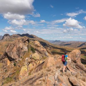 Small group of people  hiking high up over the beautiful landscape, villages in Isalo national park. Madagascar